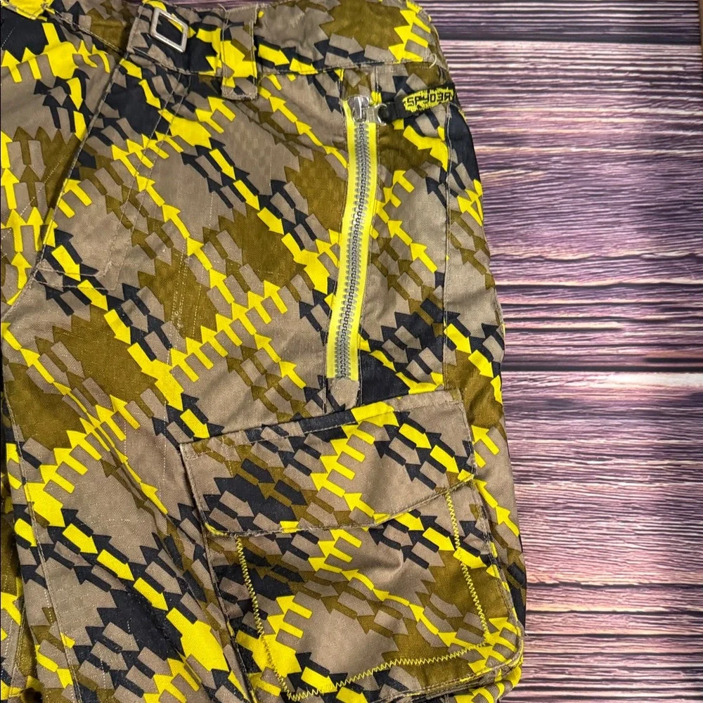 SPYDER Boys' Propulsion ski pants with an olive, black, and yellow plaid pattern